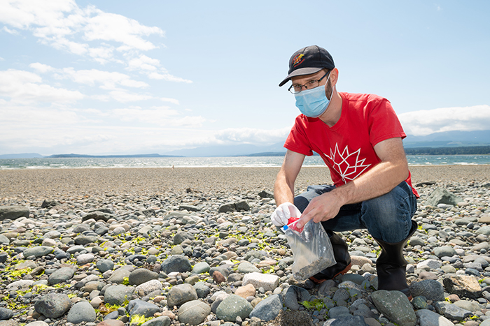 NIC student volunteer collects samples at Goose Spit in Comox