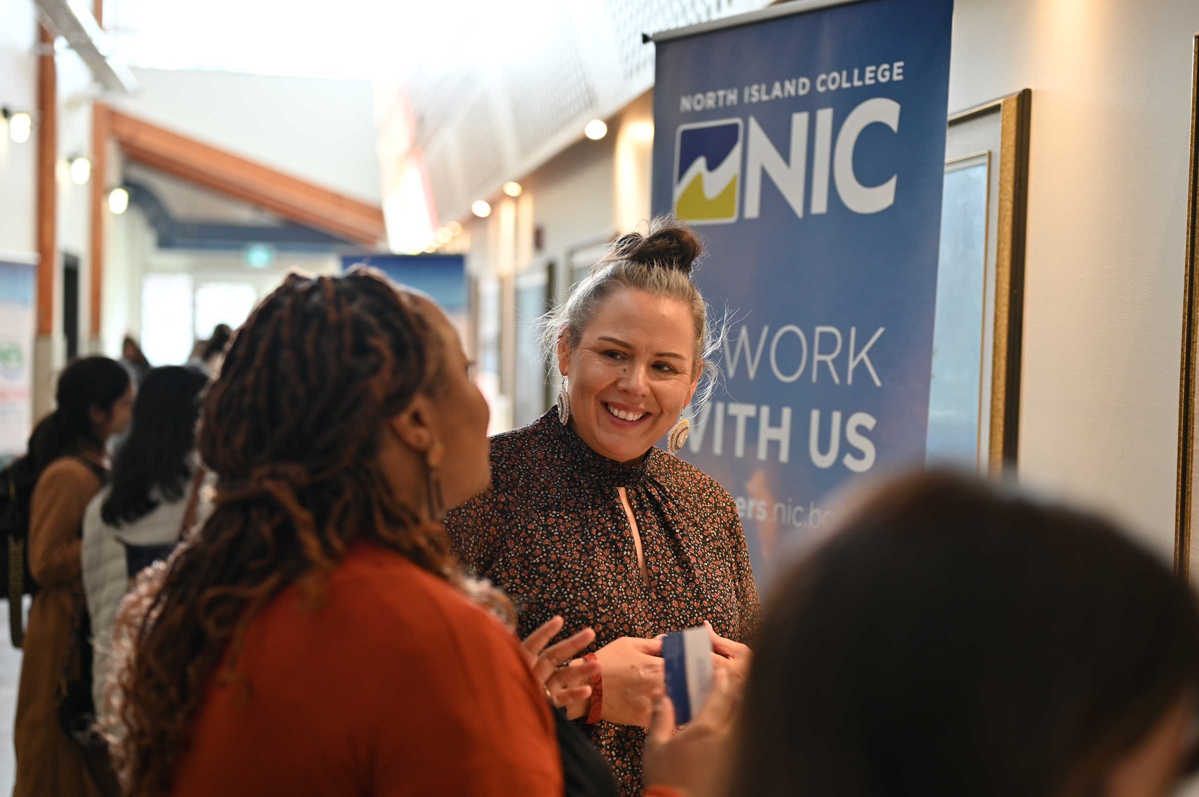 A student engages in conversation with an NIC employee at the NIC Fest job fair