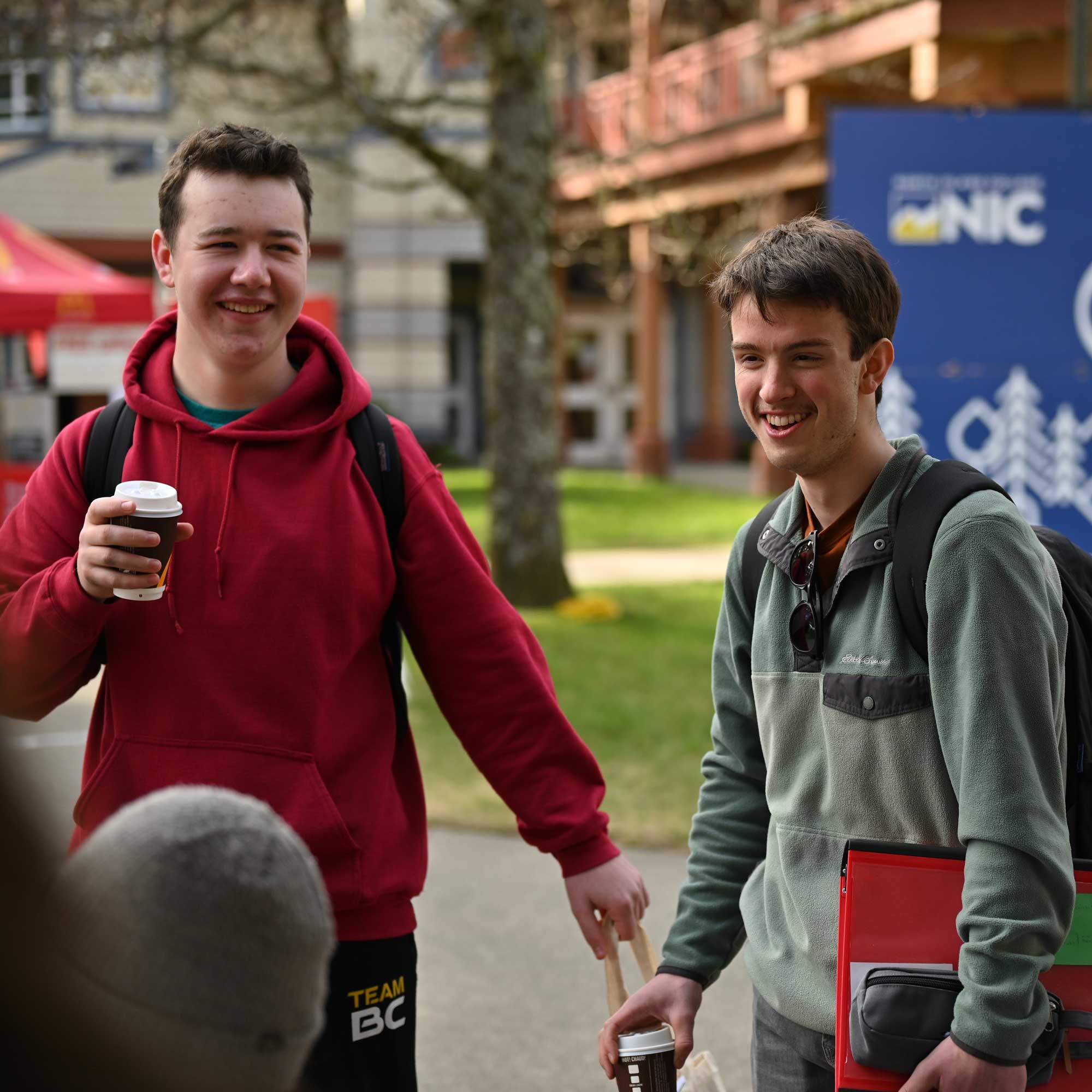 Students engaging with NIC representatives at an information booth at NIC Fest