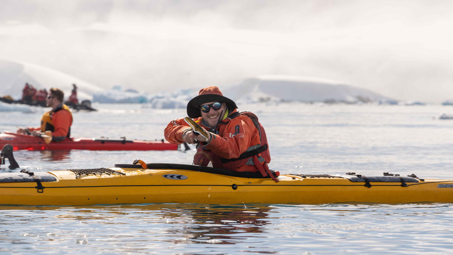 A man kayaks in Antartica