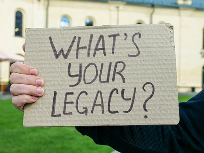 A sign asking the audience "What's your legacy?"