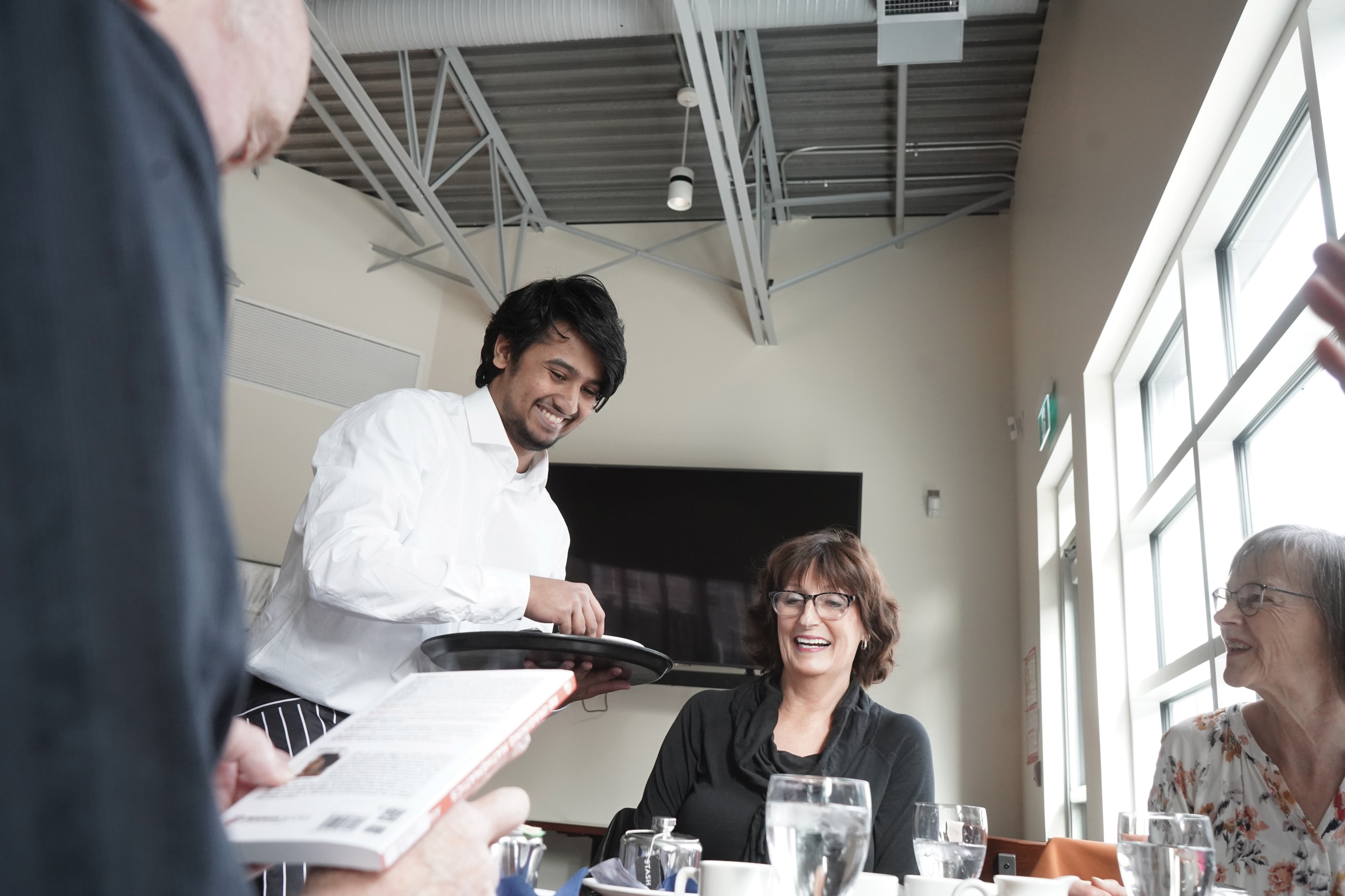 Student serving customers at The Bistro, Campbell River