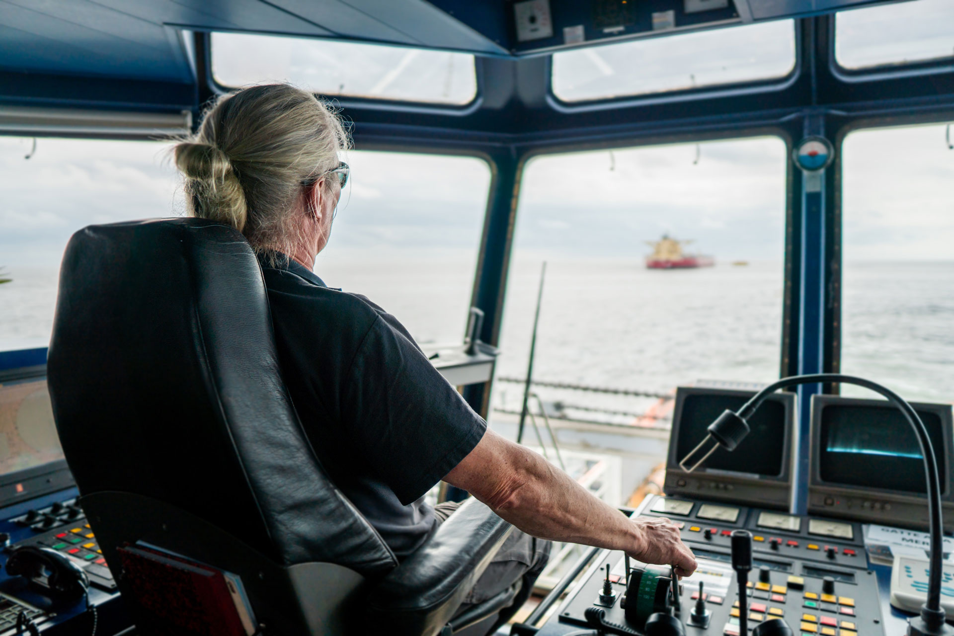 captain on deck of bridge of vessel or ship