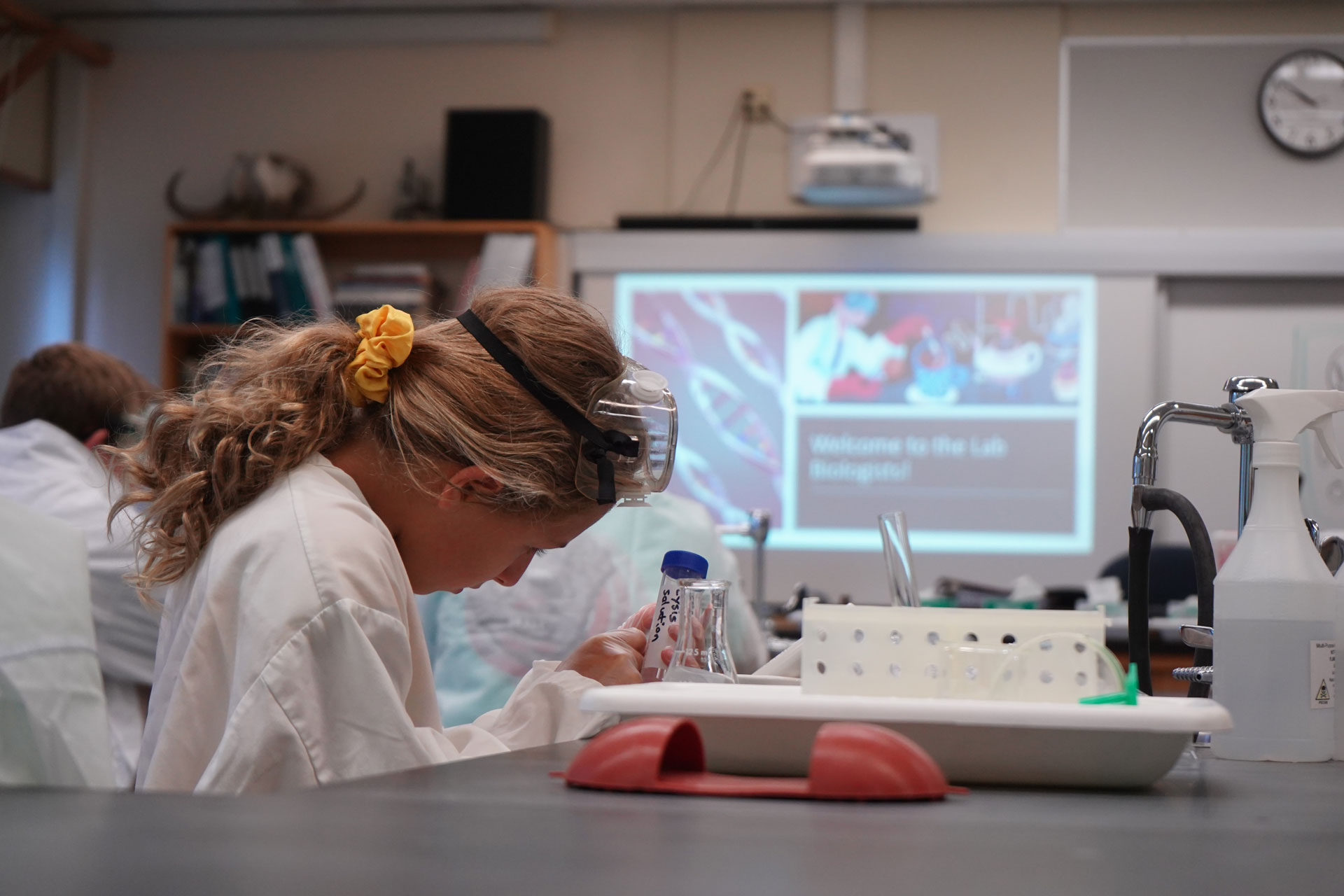 Youth Academy Summer Camp STEM participant in a science lab wearing PPE